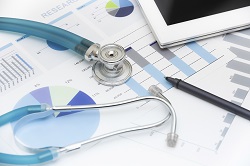 Image of stethoscope, charts, graphs, and a tablet computer