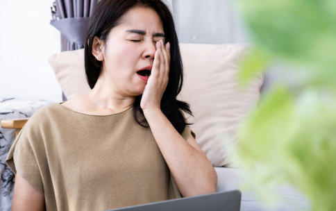 Picture of person yawning while sitting down