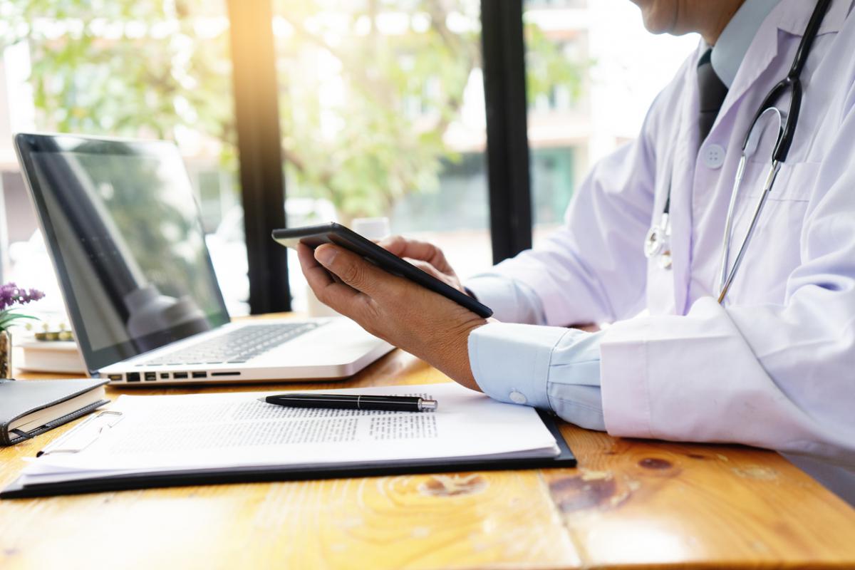 Telemedicine depiction of a physician holding a mobile device