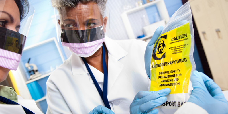 Two doctors looking at a chemotherapy drug