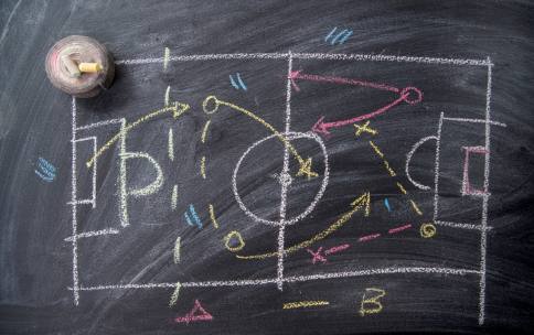 A drawing of a sports field with a play-by-play on a chalkboard