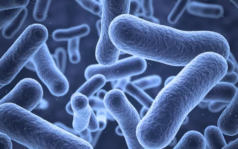 Blue bacteria floating on a dark background