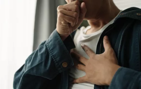 Image of man coughing